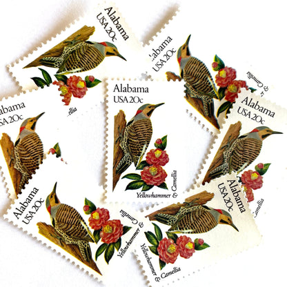 Image of Alabama State Bird and Flower postage stamps from 1982, featuring a Yellowhammer and Camellia on vintage unused 20-cent USPS postage, Scott 1953.