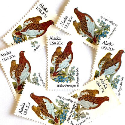 Alaska State Bird and Flower postage stamps from 1982 featuring a Willow Ptarmigan and Forget-Me-Not on vintage unused 20-cent USPS postage, Scott 1954.