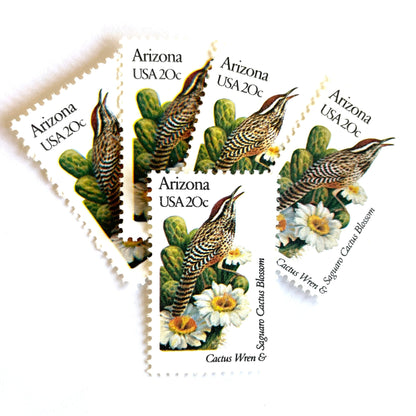 Image of Arizona State Bird and Flower postage stamps from 1982, featuring a Cactus Wren and Saguaro cactus blossom on vintage unused 20-cent USPS postage, Scott 1955.