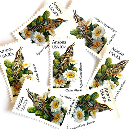 Image of Arizona State Bird and Flower postage stamps from 1982, featuring a Cactus Wren and Saguaro cactus blossom on vintage unused 20-cent USPS postage, Scott 1955.