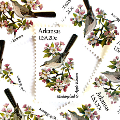 Image of Arkansas State Bird and Flower postage stamps from 1982, featuring a Mockingbird and Apple Blossom on vintage unused 20-cent USPS postage, Scott 1956.