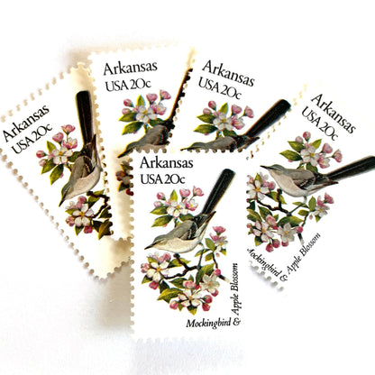 Image of Arkansas State Bird and Flower postage stamps from 1982, featuring a Mockingbird and Apple Blossom on vintage unused 20-cent USPS postage, Scott 1956.