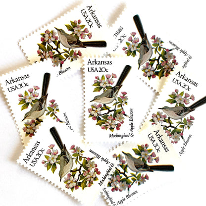 Image of Arkansas State Bird and Flower postage stamps from 1982, featuring a Mockingbird and Apple Blossom on vintage unused 20-cent USPS postage, Scott 1956.