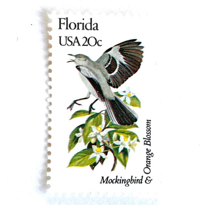 Image of Florida State Bird and Flower postage stamps from 1982, featuring a Mockingbird and Orange Blossom on vintage unused 20-cent USPS postage, Scott 1961.