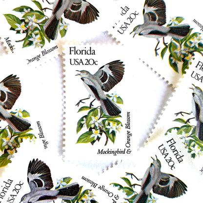 Image of Florida State Bird and Flower postage stamps from 1982, featuring a Mockingbird and Orange Blossom on vintage unused 20-cent USPS postage, Scott 1961.