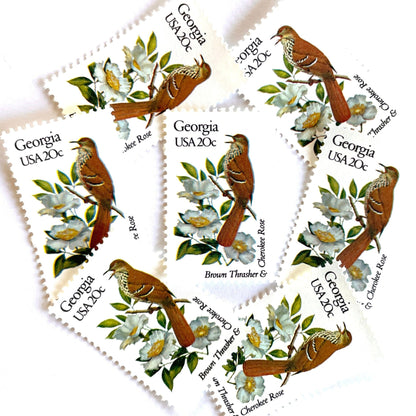 Image of Georgia State Bird and Flower postage stamps from 1982, featuring a Brown Thrasher and Cherokee Rose on vintage unused 20-cent USPS postage, Scott 1962.