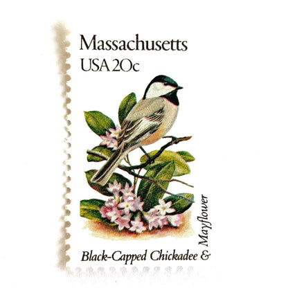 Image of Massachusetts State Bird and Flower postage stamps from 1982, featuring a Black-Capped Chickadee and Mayflower on vintage unused 20-cent USPS postage, Scott 1973.
