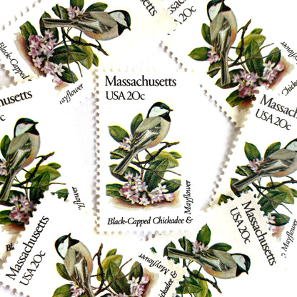 Image of Massachusetts State Bird and Flower postage stamps from 1982, featuring a Black-Capped Chickadee and Mayflower on vintage unused 20-cent USPS postage, Scott 1973.