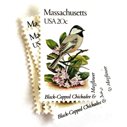Image of Massachusetts State Bird and Flower postage stamps from 1982, featuring a Black-Capped Chickadee and Mayflower on vintage unused 20-cent USPS postage, Scott 1973.