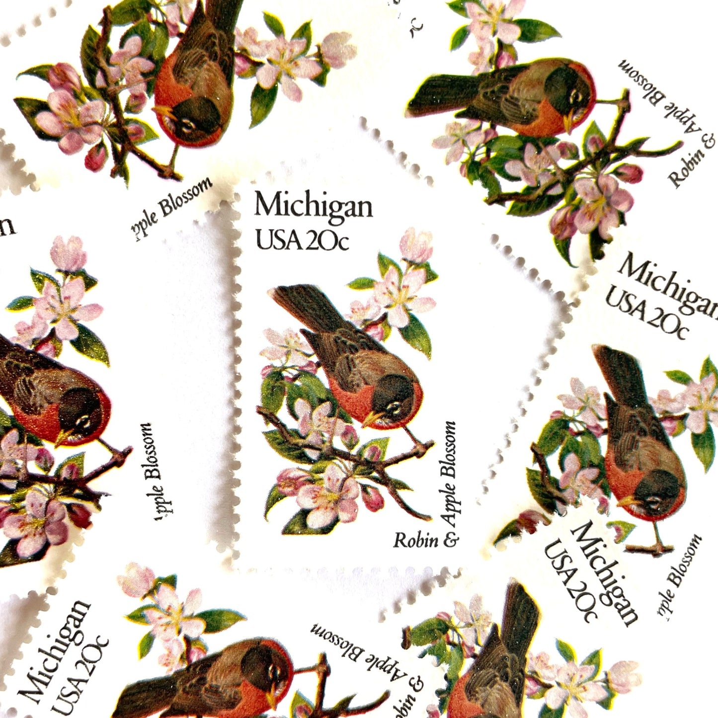 Image of Michigan State Bird and Flower postage stamps from 1982, featuring a Robin and Apple Blossom on vintage unused 20-cent USPS postage, Scott 1974.