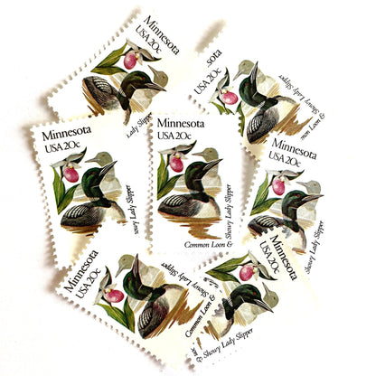 Image of Minnesota State Bird and Flower postage stamps from 1982, featuring a Common Loon and Pink and White Lady’s Slipper on vintage unused 20-cent USPS postage, Scott 1975.
