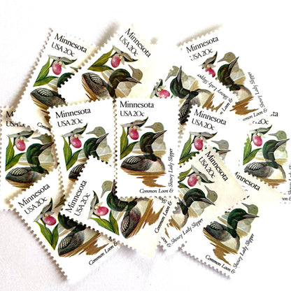 Image of Minnesota State Bird and Flower postage stamps from 1982, featuring a Common Loon and Pink and White Lady’s Slipper on vintage unused 20-cent USPS postage, Scott 1975.