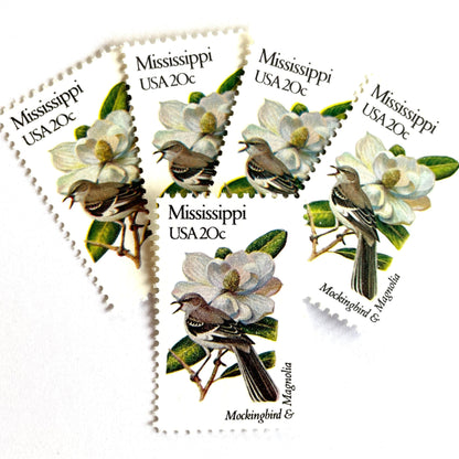 Image of 1982 State Birds & Flowers Mississippi (Mockingbird & Magnolia) 20 cent stamps. Scott #1976. Stamp themes: Birds, Aviary, Flowers, Flora, White Flower, Mississippi State Bird, Mississippi State Flower. White postage stamp.