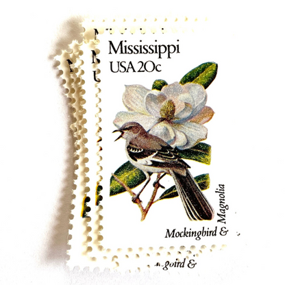 Image of 1982 State Birds & Flowers Mississippi (Mockingbird & Magnolia) 20 cent stamps. Scott #1976. Stamp themes: Birds, Aviary, Flowers, Flora, White Flower, Mississippi State Bird, Mississippi State Flower. White postage stamp.