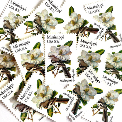 Image of 1982 State Birds & Flowers Mississippi (Mockingbird & Magnolia) 20 cent stamps. Scott #1976. Stamp themes: Birds, Aviary, Flowers, Flora, White Flower, Mississippi State Bird, Mississippi State Flower. White postage stamp.