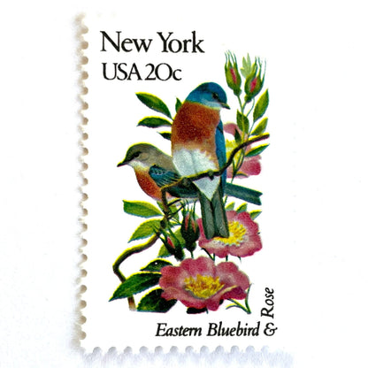 Image of New York State Bird and Flower postage stamps from 1982, featuring a Bluebird and Rose on vintage unused 20-cent USPS postage, Scott 1984.