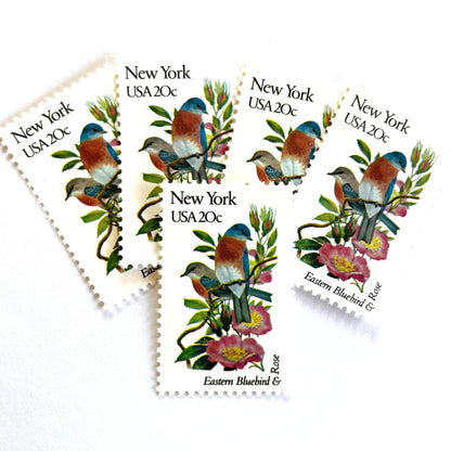 Image of New York State Bird and Flower postage stamps from 1982, featuring a Bluebird and Rose on vintage unused 20-cent USPS postage, Scott 1984.
