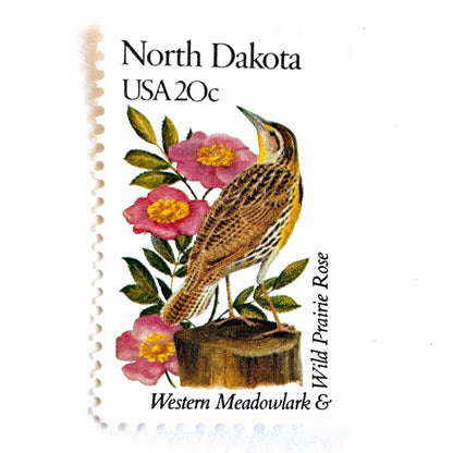 Image of North Dakota State Bird and Flower postage stamps from 1982, featuring a Western Meadowlark and Wild Prairie Rose on vintage unused 20-cent USPS postage, Scott 1986.