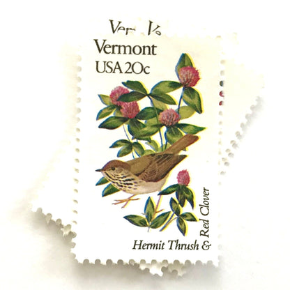 Vermont State Bird and Flower postage stamps from 1982 featuring a Hermit Thrush and Red Clover on vintage unused 20-cent USPS postage, Scott 1997.