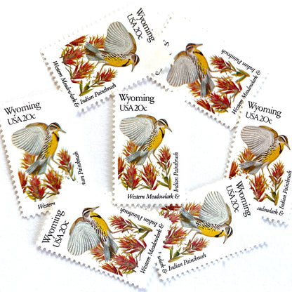 Wyoming State Bird and Flower postage stamps from 1982 featuring a Western Meadowlark and Indian Paintbrush on vintage unused 20-cent USPS postage, Scott 2002.
