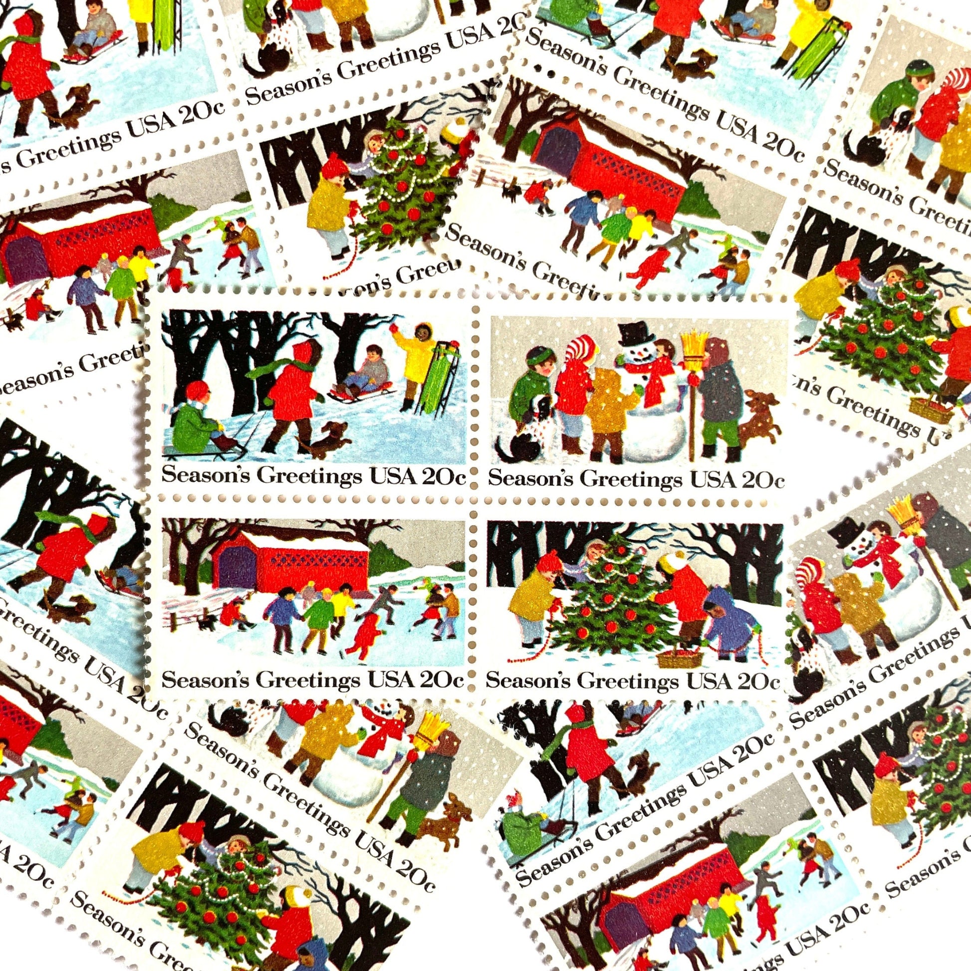 Image of 1982 Contemporary Christmas “Season's Greetings” 20 cent stamps. Scott #2027-30. Stamp Themes: Christmas, Holidays, Winter, Sledding, Ice Skating, Snowman Building, Christmas Tree Decorating, Snow, Cold, Children Playing. Christmas Issue Se-Tenant set of four connected stamps.