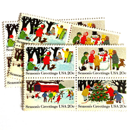 Image of 1982 Contemporary Christmas “Season's Greetings” 20 cent stamps. Scott #2027-30. Stamp Themes: Christmas, Holidays, Winter, Sledding, Ice Skating, Snowman Building, Christmas Tree Decorating, Snow, Cold, Children Playing. Christmas Issue Se-Tenant set of four connected stamps.