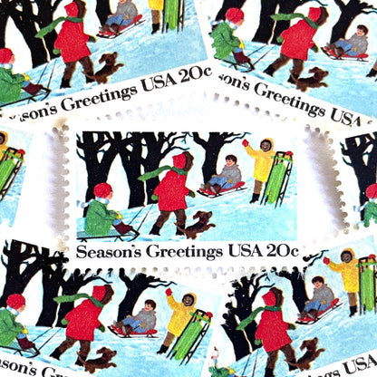 Image of 1982 Contemporary Christmas “Sledding” 20-cent stamps. Scott #2027. Stamp Themes: Christmas, Sledding, Snow, Children, Playing, Winter, Season’s Greetings. White postage stamp.