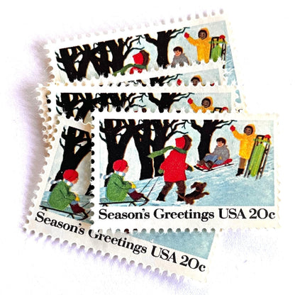 Image of 1982 Contemporary Christmas “Sledding” 20-cent stamps. Scott #2027. Stamp Themes: Christmas, Sledding, Snow, Children, Playing, Winter, Season’s Greetings. White postage stamp.