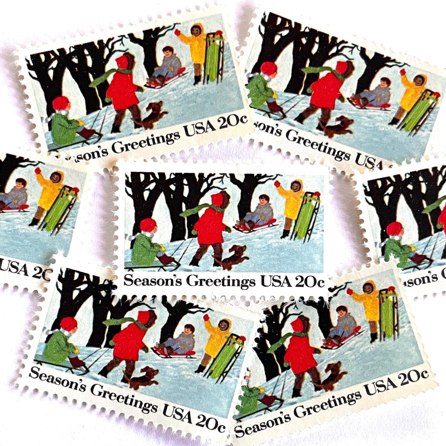 Image of 1982 Contemporary Christmas “Sledding” 20-cent stamps. Scott #2027. Stamp Themes: Christmas, Sledding, Snow, Children, Playing, Winter, Season’s Greetings. White postage stamp.