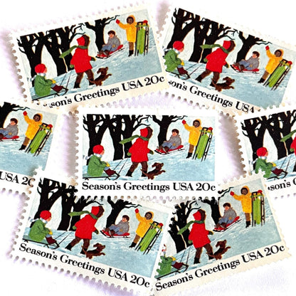 Image of 1982 Contemporary Christmas “Sledding” 20-cent stamps. Scott #2027. Stamp Themes: Christmas, Sledding, Snow, Children, Playing, Winter, Season’s Greetings. White postage stamp.