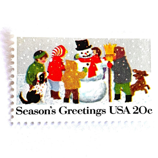 Image of 1982 Contemporary Christmas “Building a Snowman” 20-cent stamps. Scott #2028. Stamp Themes: Snowman, Christmas, Holidays, Winter, Children, Playing, Snowing, Season’s Greetings. White postage stamp.