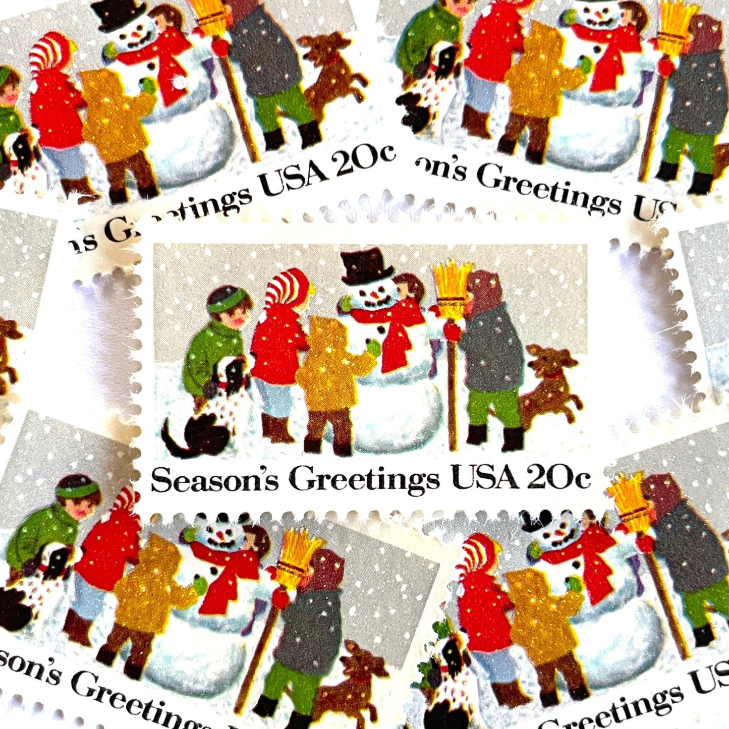 Image of 1982 Contemporary Christmas “Building a Snowman” 20-cent stamps. Scott #2028. Stamp Themes: Snowman, Christmas, Holidays, Winter, Children, Playing, Snowing, Season’s Greetings. White postage stamp.