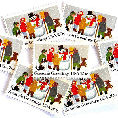 Image of 1982 Contemporary Christmas “Building a Snowman” 20-cent stamps. Scott #2028. Stamp Themes: Snowman, Christmas, Holidays, Winter, Children, Playing, Snowing, Season’s Greetings. White postage stamp.