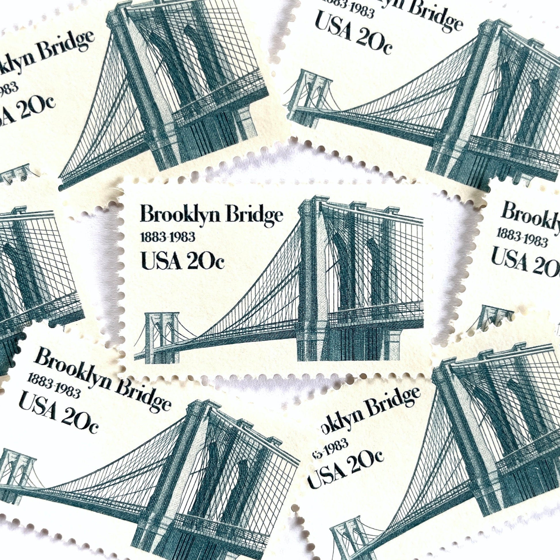 Image of 1983 “Brooklyn Bridge” 20-cent mail stamps. Scott #2041. Stamp Themes: 100th Anniversary of the Brooklyn Bridge, 8th Wonder of the World, NYC, New York City, Brooklyn. Blue postage stamp.