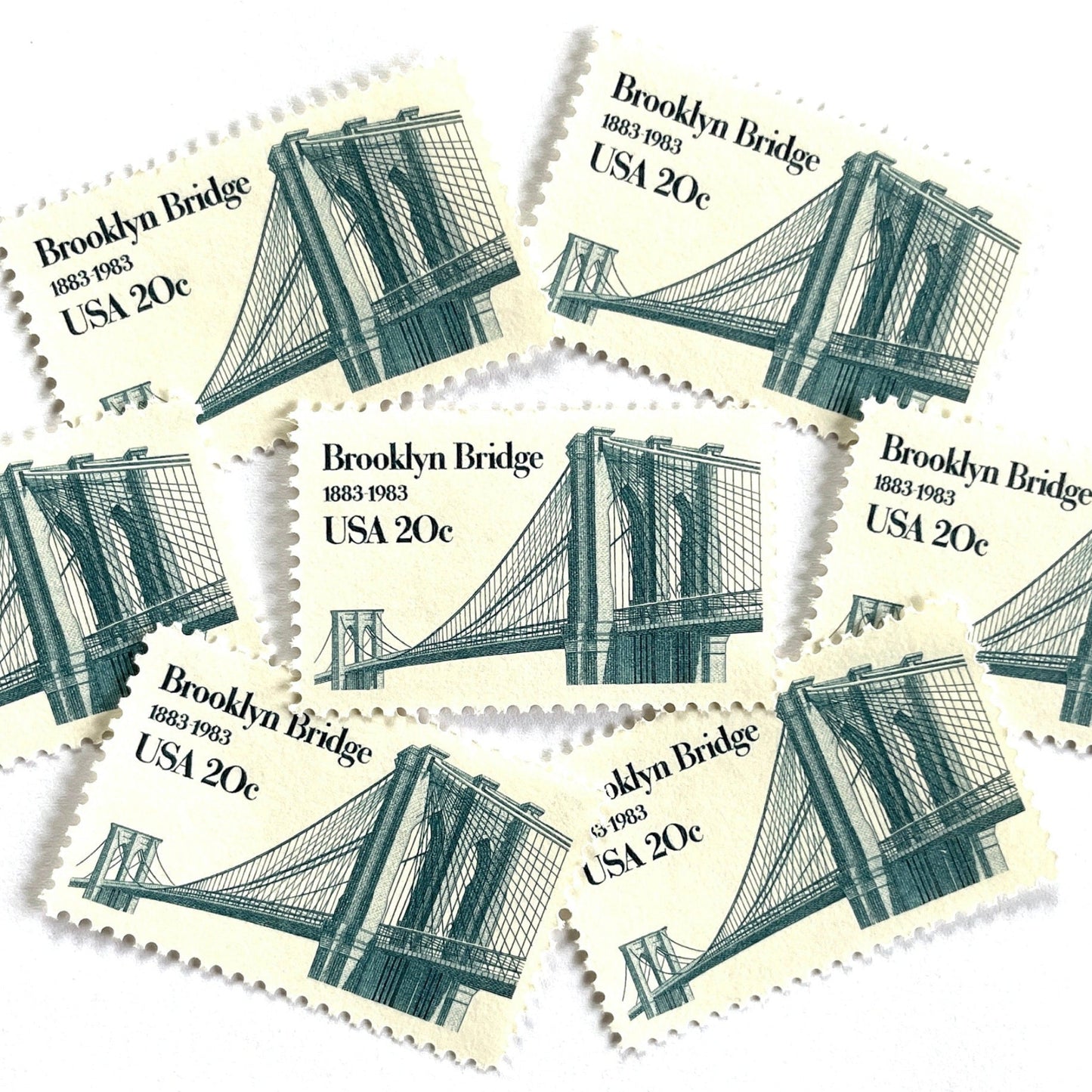 Image of 1983 “Brooklyn Bridge” 20-cent mail stamps. Scott #2041. Stamp Themes: 100th Anniversary of the Brooklyn Bridge, 8th Wonder of the World, NYC, New York City, Brooklyn. Blue postage stamp.