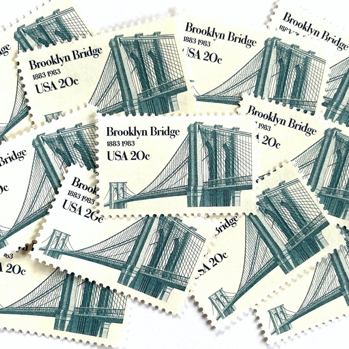Image of 1983 “Brooklyn Bridge” 20-cent mail stamps. Scott #2041. Stamp Themes: 100th Anniversary of the Brooklyn Bridge, 8th Wonder of the World, NYC, New York City, Brooklyn. Blue postage stamp.