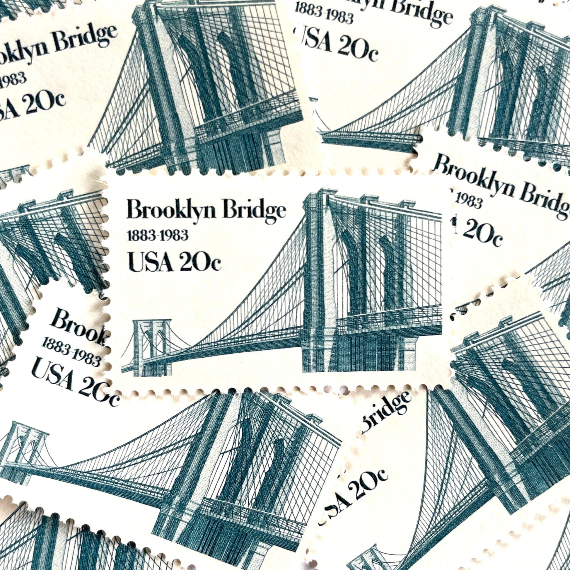 Image of 1983 “Brooklyn Bridge” 20-cent mail stamps. Scott #2041. Stamp Themes: 100th Anniversary of the Brooklyn Bridge, 8th Wonder of the World, NYC, New York City, Brooklyn. Blue postage stamp.