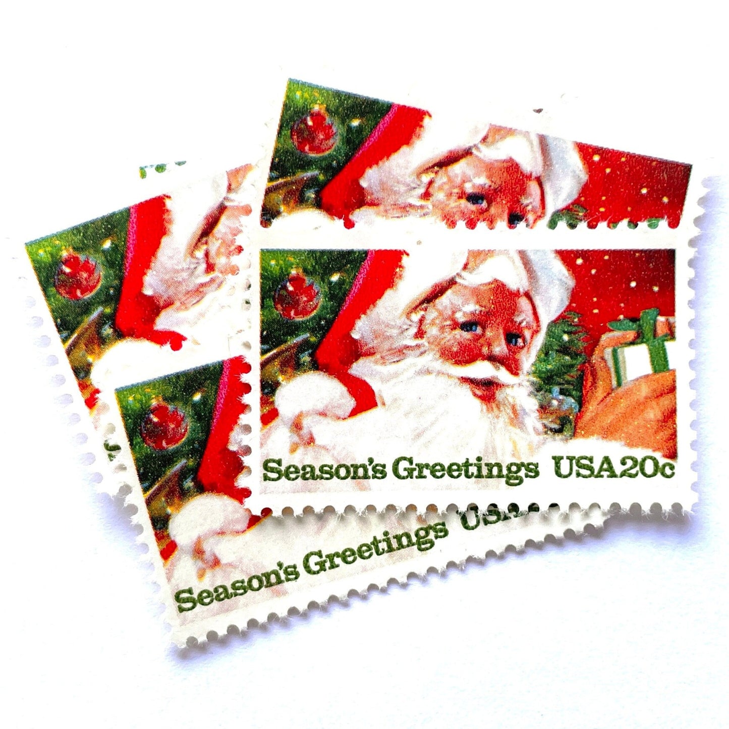 Image of 1983 Contemporary Christmas “Santa Claus” 20 cent stamps. Scott #2064. Stamp Themes: Santa Claus, Jolly St. Nick, Christmas, Holidays, Presents, Season's Greetings, Christmas Tree. Red and green postage stamp.