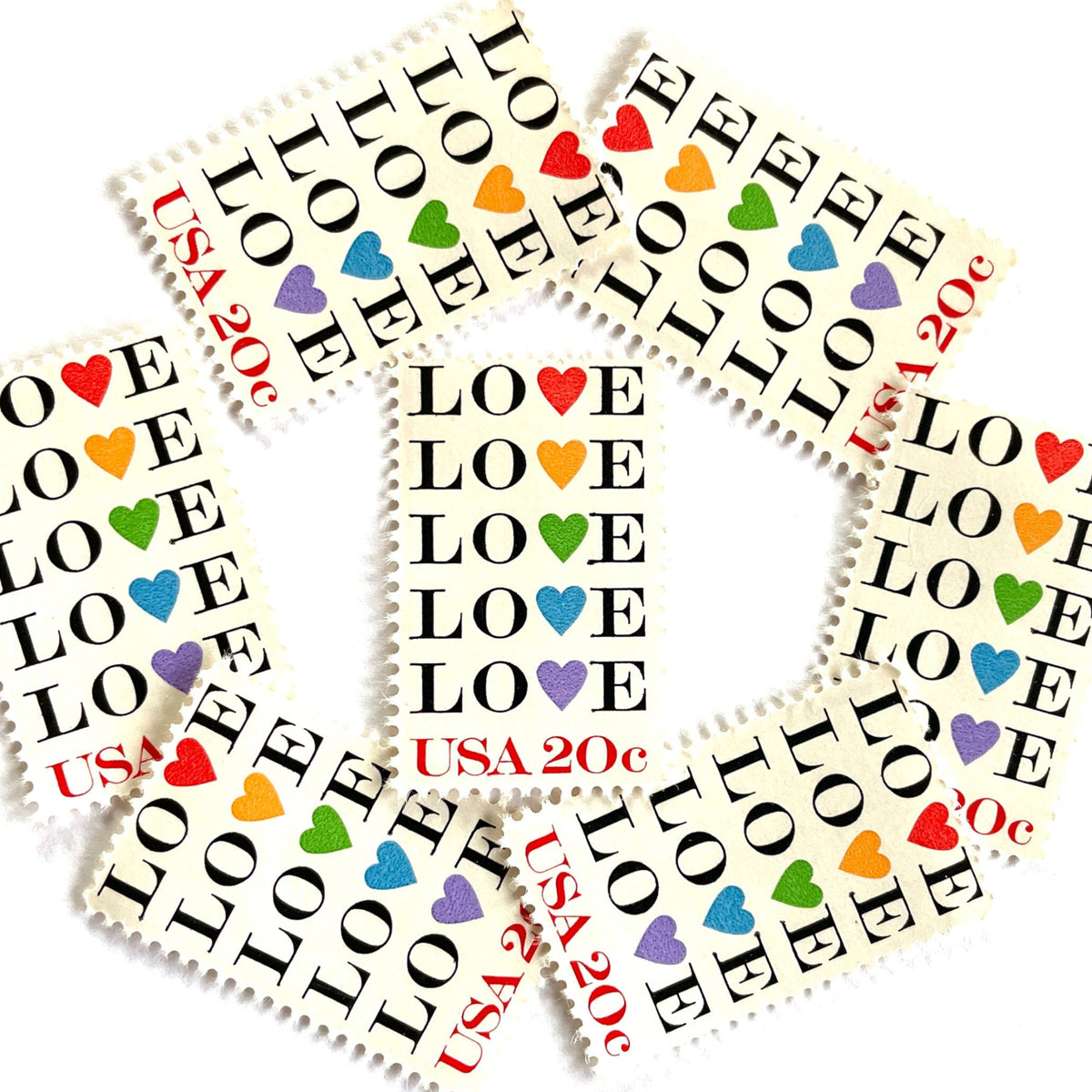 Love with Hearts postage stamps from 1984 featuring repeated LOVE lettering with five different-colored hearts on vintage unused 20-cent USPS postage, Scott 2072.