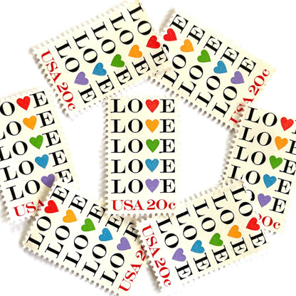 Love with Hearts postage stamps from 1984 featuring repeated LOVE lettering with five different-colored hearts on vintage unused 20-cent USPS postage, Scott 2072.