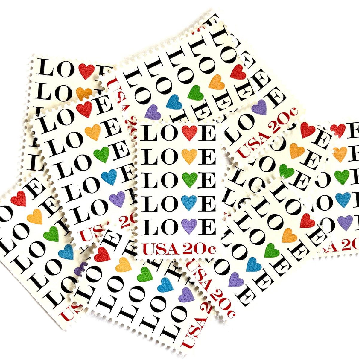 Love with Hearts postage stamps from 1984 featuring repeated LOVE lettering with five different-colored hearts on vintage unused 20-cent USPS postage, Scott 2072.