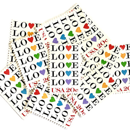 Love with Hearts postage stamps from 1984 featuring repeated LOVE lettering with five different-colored hearts on vintage unused 20-cent USPS postage, Scott 2072.