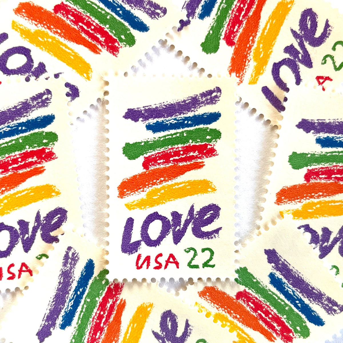 Love Crayon postage stamps from 1985 featuring colorful brush strokes and bold purple LOVE lettering on vintage unused 22-cent USPS postage, Scott 2143.