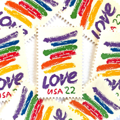 Love Crayon postage stamps from 1985 featuring colorful brush strokes and bold purple LOVE lettering on vintage unused 22-cent USPS postage, Scott 2143.