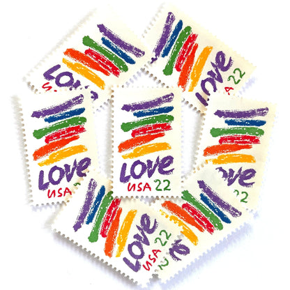 Love Crayon postage stamps from 1985 featuring colorful brush strokes and bold purple LOVE lettering on vintage unused 22-cent USPS postage, Scott 2143.