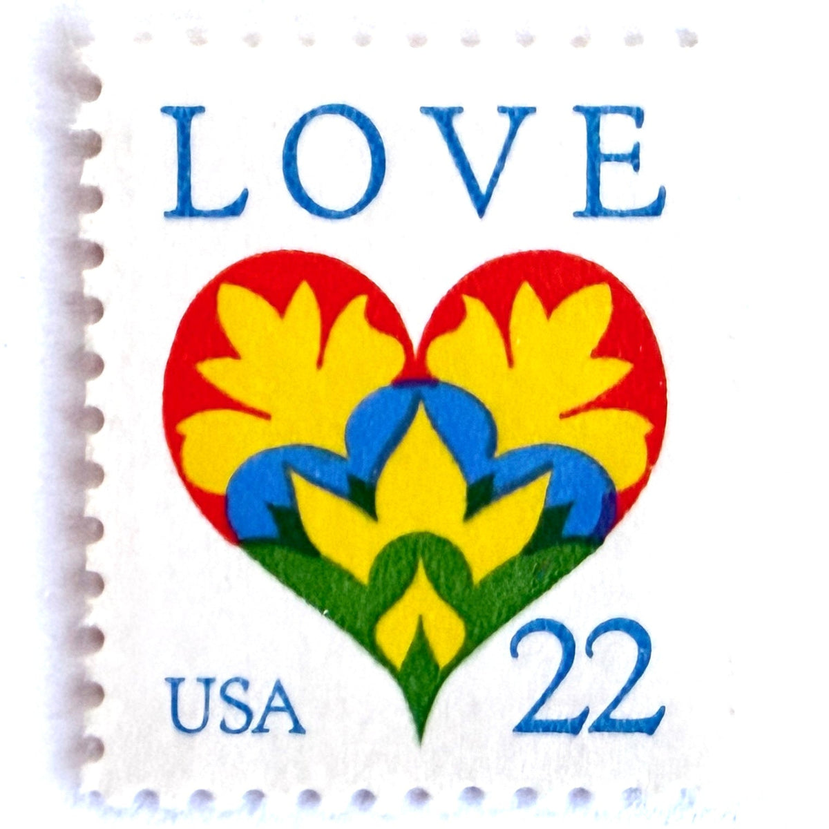 Hearts & Flowers postage stamp from 1987 featuring a colorful folk art heart surrounded by flowers on vintage unused 22-cent USPS postage, Scott 2248.