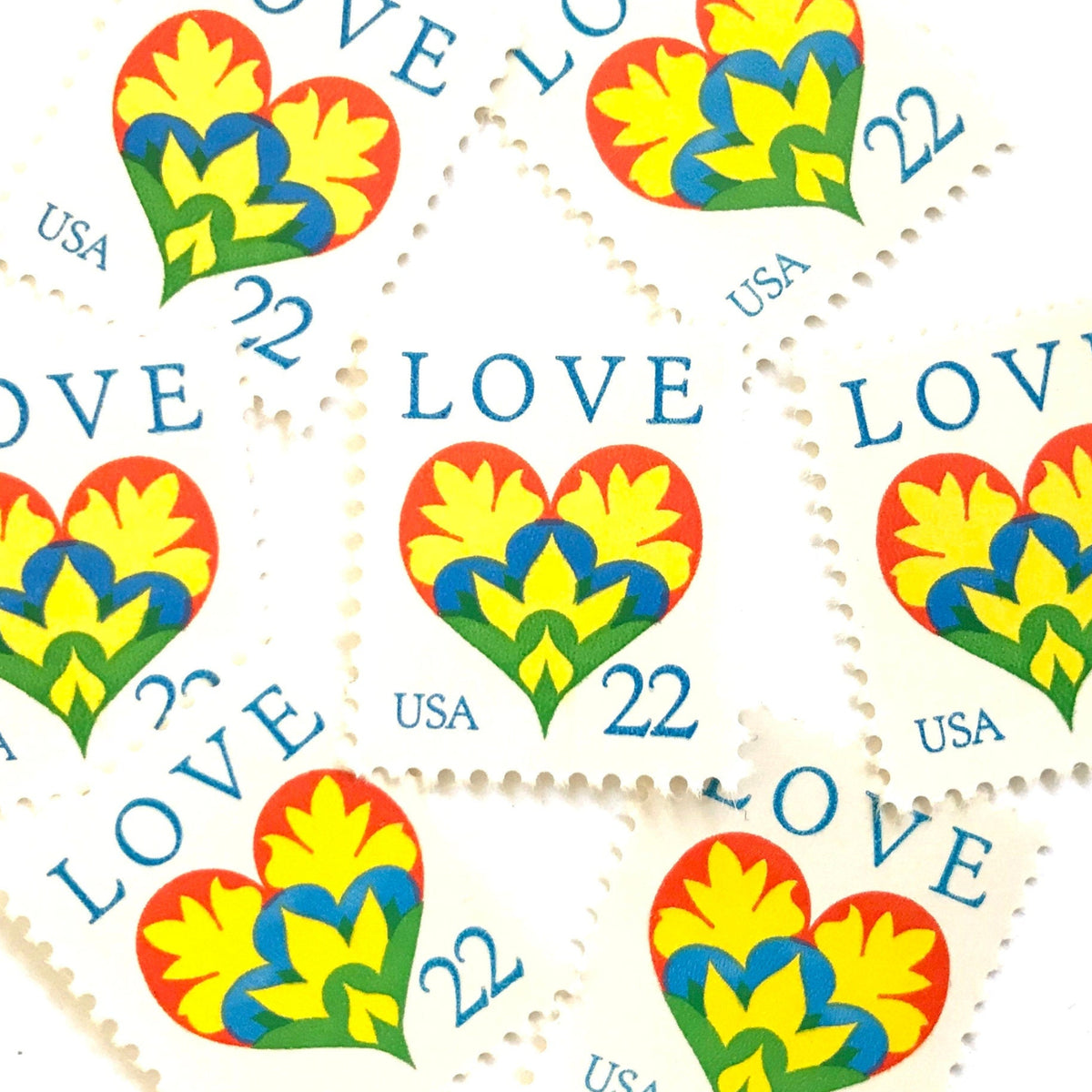 Hearts & Flowers postage stamps from 1987 featuring a colorful folk art heart surrounded by flowers on vintage unused 22-cent USPS postage, Scott 2248.