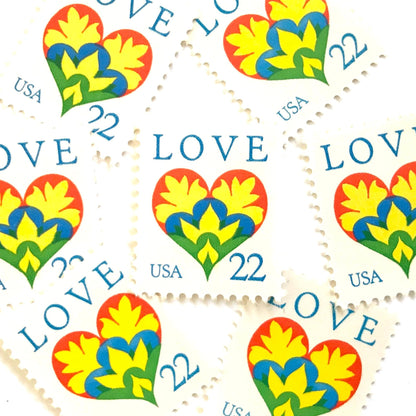 Hearts & Flowers postage stamps from 1987 featuring a colorful folk art heart surrounded by flowers on vintage unused 22-cent USPS postage, Scott 2248.