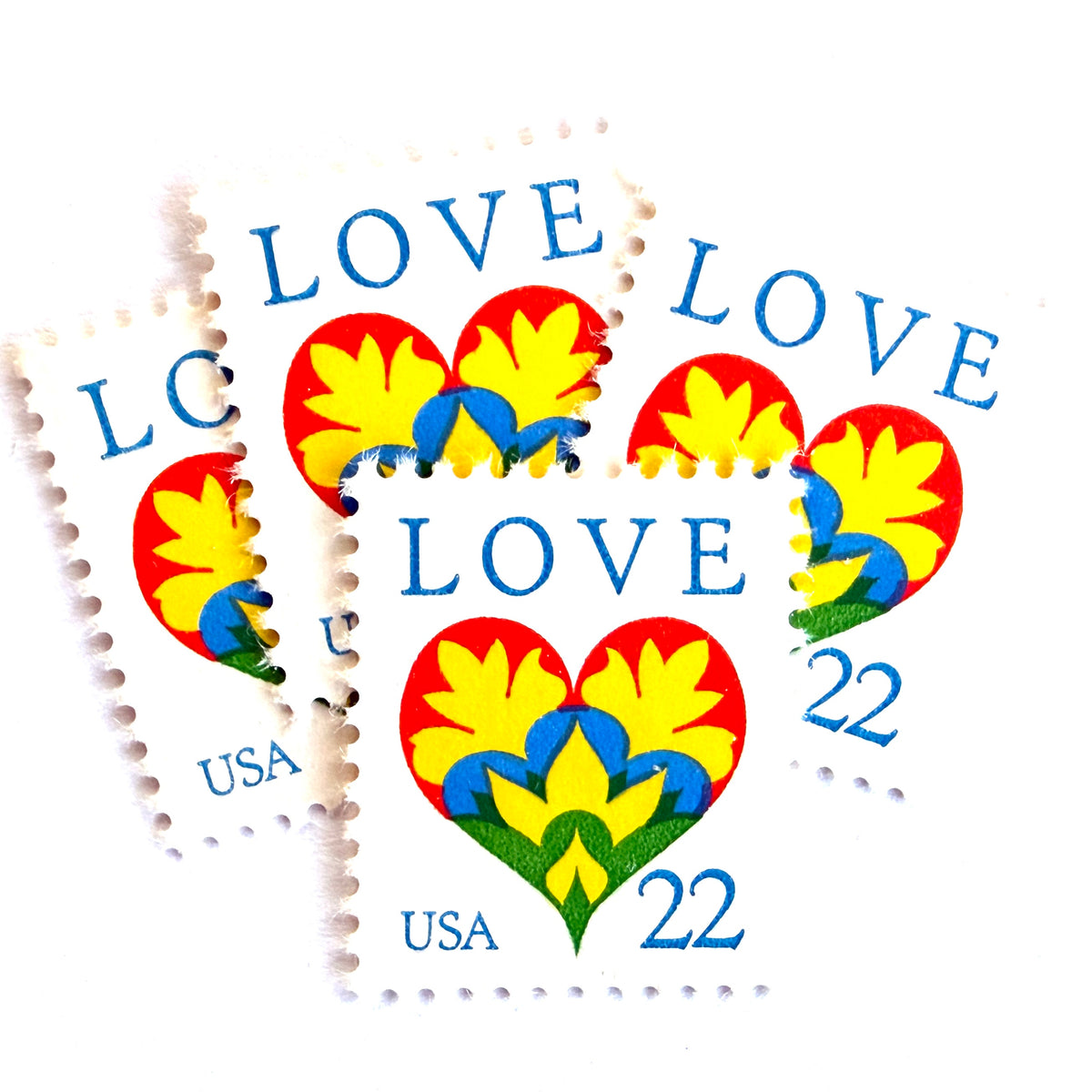Hearts & Flowers postage stamps from 1987 featuring a colorful folk art heart surrounded by flowers on vintage unused 22-cent USPS postage, Scott 2248.