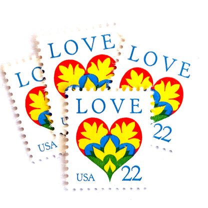 Hearts & Flowers postage stamps from 1987 featuring a colorful folk art heart surrounded by flowers on vintage unused 22-cent USPS postage, Scott 2248.